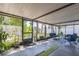 Large screened patio with comfortable seating and view of landscaped backyard at 12838 Tallowood Dr, Riverview, FL 33579