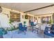Cozy covered patio with comfortable seating and decorative touches. Plants and American Flag at 12838 Tallowood Dr, Riverview, FL 33579