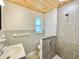 Stylish bathroom with a wood plank ceiling and tiled shower at 1290 Michigan Blvd, Dunedin, FL 34698