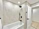 Modern bathroom features sleek shower/tub combo and stone-style tile at 1290 Michigan Blvd, Dunedin, FL 34698