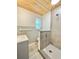 Charming bathroom with a wood plank ceiling and tiled shower at 1290 Michigan Blvd, Dunedin, FL 34698