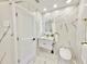 Modern bathroom features marble-style tile, illuminated mirror, and sleek fixtures at 1290 Michigan Blvd, Dunedin, FL 34698
