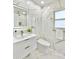 Modern bathroom features marble-style tile, illuminated mirror, and sleek fixtures at 1290 Michigan Blvd, Dunedin, FL 34698