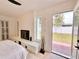 Bright bedroom features a fireplace, backyard access and views of the outdoor space at 1290 Michigan Blvd, Dunedin, FL 34698