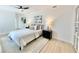 Bright bedroom boasts a modern ceiling fan, contemporary decor, and hardwood floors at 1290 Michigan Blvd, Dunedin, FL 34698