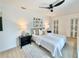 Bright bedroom features a modern ceiling fan, artful decor, and natural light at 1290 Michigan Blvd, Dunedin, FL 34698