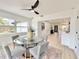 Open-concept dining area with a glass table, modern chairs, and natural light makes for a welcoming space at 1290 Michigan Blvd, Dunedin, FL 34698