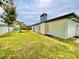 Backyard showcasing the modern home design and well-maintained lawn at 1290 Michigan Blvd, Dunedin, FL 34698