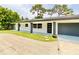 Well-maintained home with a manicured front lawn and modern architecture at 1290 Michigan Blvd, Dunedin, FL 34698