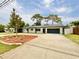 Inviting single-story home with a well-maintained lawn and a paved driveway at 1290 Michigan Blvd, Dunedin, FL 34698