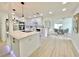 Open-concept kitchen featuring stainless appliances, an island with pendant lighting, and bright, airy space at 1290 Michigan Blvd, Dunedin, FL 34698