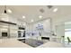 Modern kitchen features stainless steel appliances, an island cooktop, and white cabinets with black hardware at 1290 Michigan Blvd, Dunedin, FL 34698