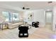 Bright living room with contemporary furniture, a large window, and an open floor plan at 1290 Michigan Blvd, Dunedin, FL 34698