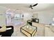 Bright and airy living room with contemporary furniture, neutral tones, and sleek ceiling fan at 1290 Michigan Blvd, Dunedin, FL 34698
