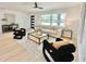 Cozy living room featuring a large window and stylish decor with modern furniture at 1290 Michigan Blvd, Dunedin, FL 34698