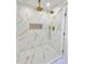 Modern shower features marble-style tile and gold fixtures at 1290 Michigan Blvd, Dunedin, FL 34698