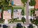 Aerial view of a home with a screened-in pool, showcasing its neighborhood setting and well-maintained grounds at 137 Woodcreek E Dr, Safety Harbor, FL 34695