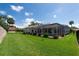 Expansive backyard featuring a screened lanai and a well-maintained lawn, ideal for outdoor activities at 137 Woodcreek E Dr, Safety Harbor, FL 34695