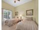 Bedroom featuring two twin beds with matching linens and neutral colored walls at 137 Woodcreek E Dr, Safety Harbor, FL 34695