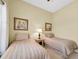Bedroom featuring two twin beds with matching linens and neutral colored walls at 137 Woodcreek E Dr, Safety Harbor, FL 34695