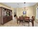 Dining room with a wood table, brown chairs, a cabinet, and a decorative chandelier at 137 Woodcreek E Dr, Safety Harbor, FL 34695