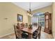 Elegant dining room with a wooden table set, chandelier, and arched window at 137 Woodcreek E Dr, Safety Harbor, FL 34695
