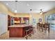 Spacious kitchen with a large island, granite countertops, modern appliances, and an adjacent breakfast nook area at 137 Woodcreek E Dr, Safety Harbor, FL 34695