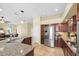 Modern kitchen with stainless steel appliances, granite countertops, and tile floors at 137 Woodcreek E Dr, Safety Harbor, FL 34695