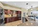 Well-equipped kitchen with stainless steel appliances, granite countertops, and dark wood cabinetry at 137 Woodcreek E Dr, Safety Harbor, FL 34695