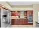 Contemporary kitchen featuring stainless steel appliances and dark wood cabinets at 137 Woodcreek E Dr, Safety Harbor, FL 34695