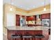 Kitchen boasts granite countertops, stainless steel appliances, and seating at the island at 137 Woodcreek E Dr, Safety Harbor, FL 34695