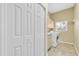 Convenient laundry room features a washer, dryer, storage cabinets, and a window for natural light at 137 Woodcreek E Dr, Safety Harbor, FL 34695