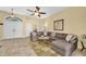 Inviting living area features a comfortable sectional sofa, tile flooring, a ceiling fan and bright, neutral paint at 137 Woodcreek E Dr, Safety Harbor, FL 34695