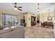 Open concept living area with tile floors, ceiling fan, dining table, and view to the lanai at 137 Woodcreek E Dr, Safety Harbor, FL 34695
