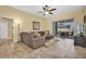 Comfortable living room featuring neutral colors, tile floors and sliding glass doors to the patio/pool area at 137 Woodcreek E Dr, Safety Harbor, FL 34695