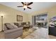 Open living room featuring tile floors, comfortable seating, and sliding glass doors to the outdoor patio area at 137 Woodcreek E Dr, Safety Harbor, FL 34695