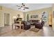 Relaxing living room with ample seating, tile flooring, and natural light from the windows at 137 Woodcreek E Dr, Safety Harbor, FL 34695