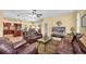 Inviting living room featuring leather furniture, tile flooring, ceiling fans, and an open layout at 137 Woodcreek E Dr, Safety Harbor, FL 34695