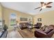 Inviting living room features large arched windows, tile floors and ceiling fan at 137 Woodcreek E Dr, Safety Harbor, FL 34695