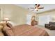 Spacious main bedroom with ensuite bathroom, ceiling fan, and neutral carpeting at 137 Woodcreek E Dr, Safety Harbor, FL 34695