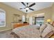 Relaxing main bedroom with a ceiling fan and natural light, offering a peaceful retreat with an exterior view at 137 Woodcreek E Dr, Safety Harbor, FL 34695