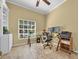 Office space featuring tile floors, a built-in bookshelf, a glass desk and two computer monitors at 137 Woodcreek E Dr, Safety Harbor, FL 34695