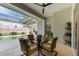 Covered patio with seating area overlooking the screened-in pool and lush backyard at 137 Woodcreek E Dr, Safety Harbor, FL 34695