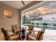 Cozy screened patio offers a comfortable seating area with scenic views of the pool and beautifully landscaped yard at 137 Woodcreek E Dr, Safety Harbor, FL 34695