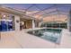 Backyard oasis featuring a screened-in pool, providing a perfect blend of relaxation and entertainment at 137 Woodcreek E Dr, Safety Harbor, FL 34695
