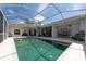 Inviting backyard pool featuring a spacious deck area and surrounded by lush landscaping for ultimate privacy at 137 Woodcreek E Dr, Safety Harbor, FL 34695