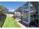 Covered pool area with nice green grass, perfect for relaxation and outdoor enjoyment at 137 Woodcreek E Dr, Safety Harbor, FL 34695