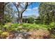 Relaxing backyard with a screened-in pool and lush greenery at 16039 Ternglade Dr, Lithia, FL 33547