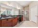 Bathroom featuring dual sinks, granite countertops, a walk-in shower, and tile flooring at 16039 Ternglade Dr, Lithia, FL 33547