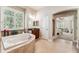 Bright bathroom with a corner jacuzzi tub, tiled floors and a glass shower at 16039 Ternglade Dr, Lithia, FL 33547
